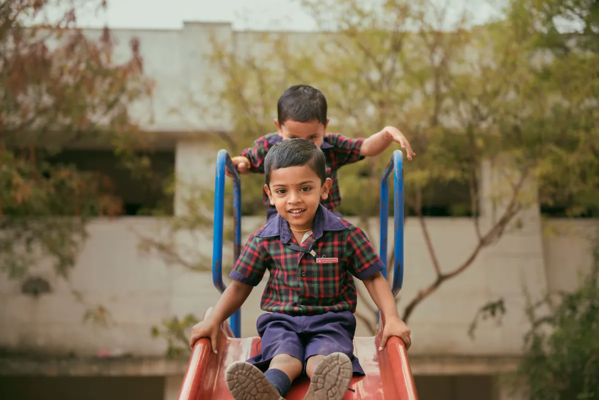 Young children playing on slide
