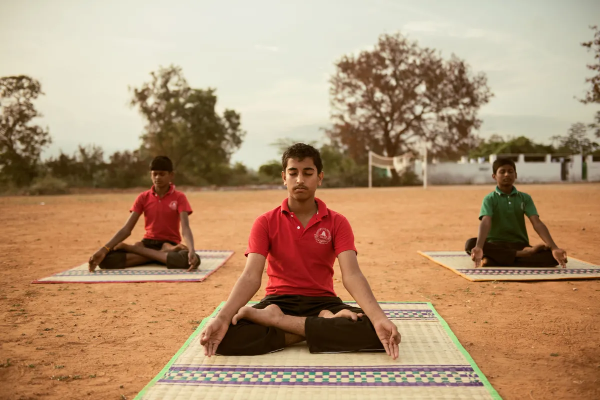 Students meditating outdoors